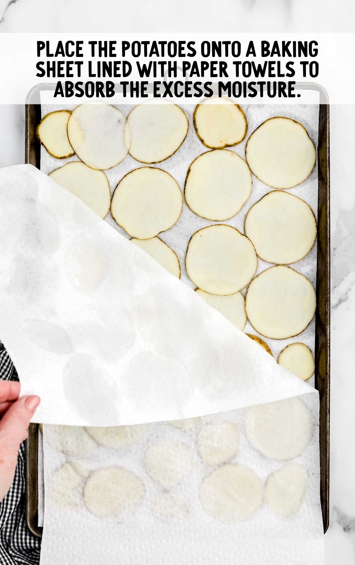 potatoes chips placed onto a baking sheet lined with paper towels