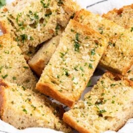 a close up shot of a multiple Air Fryer Garlic Bread in a basket