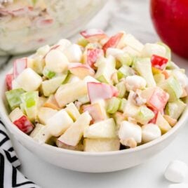 close up shot of a bowl of Apple Salad drizzled with sauce