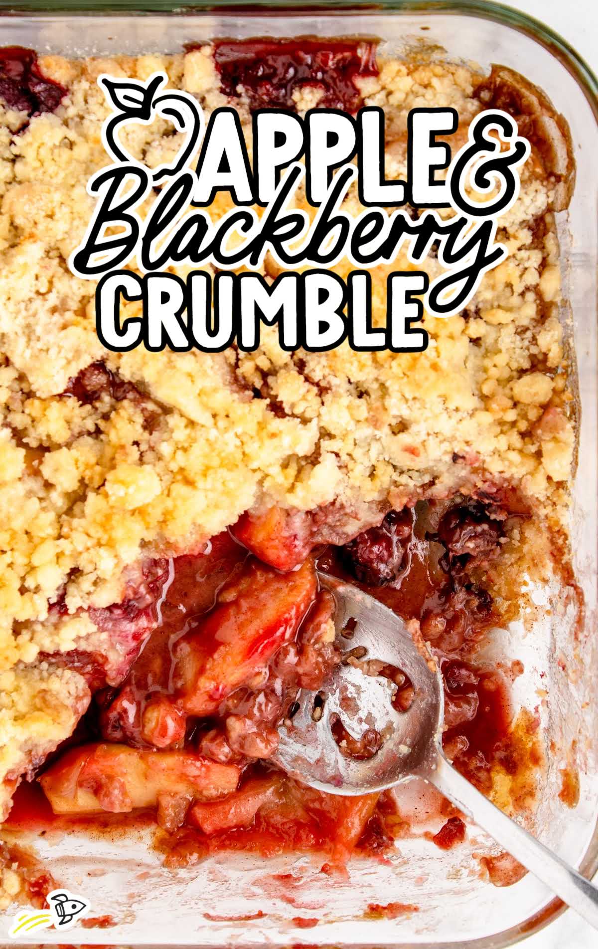 overhead shot of Apple and blackberry crumble with a spoon
