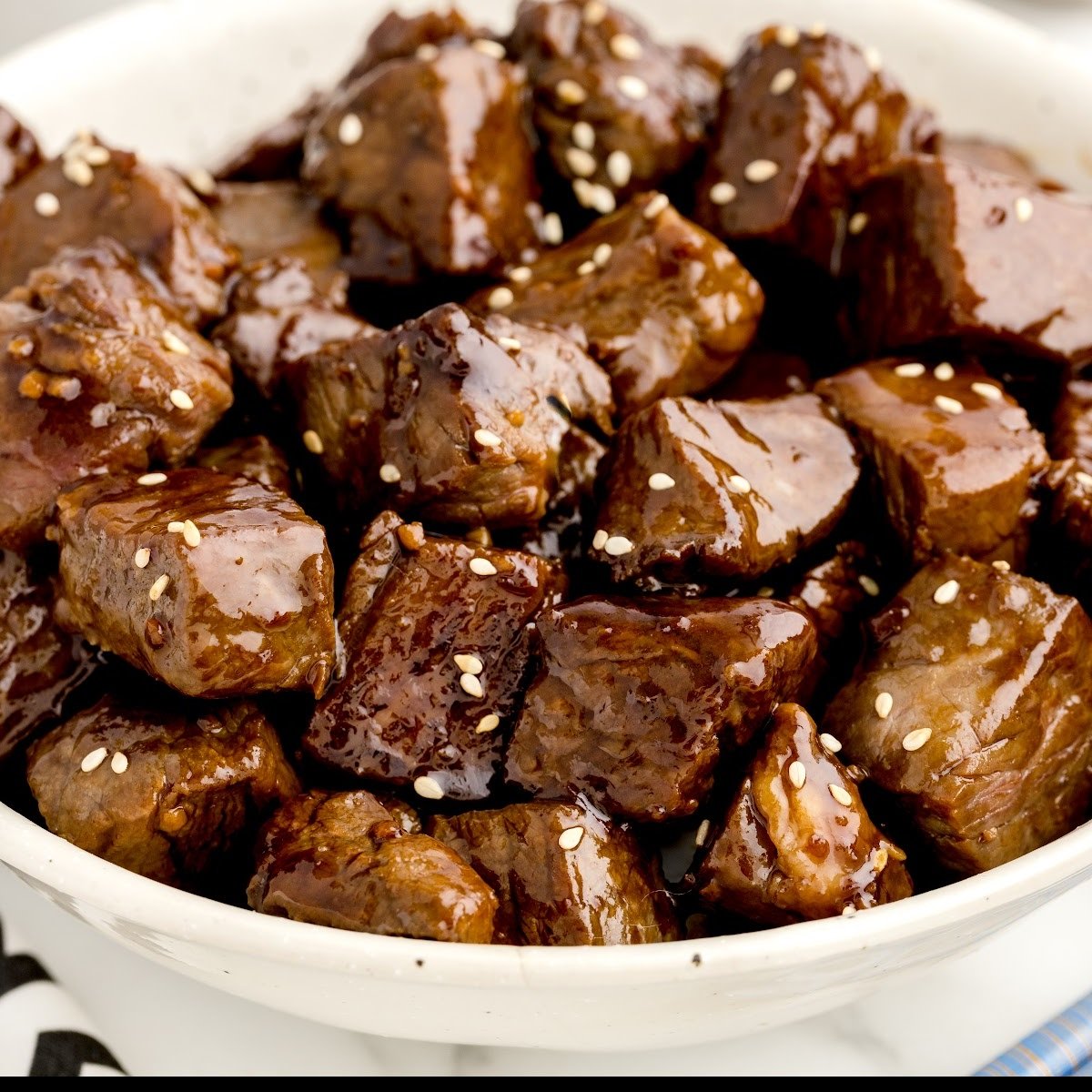 close up shot of a bowl of Steak Bites garnished with sesame seeds