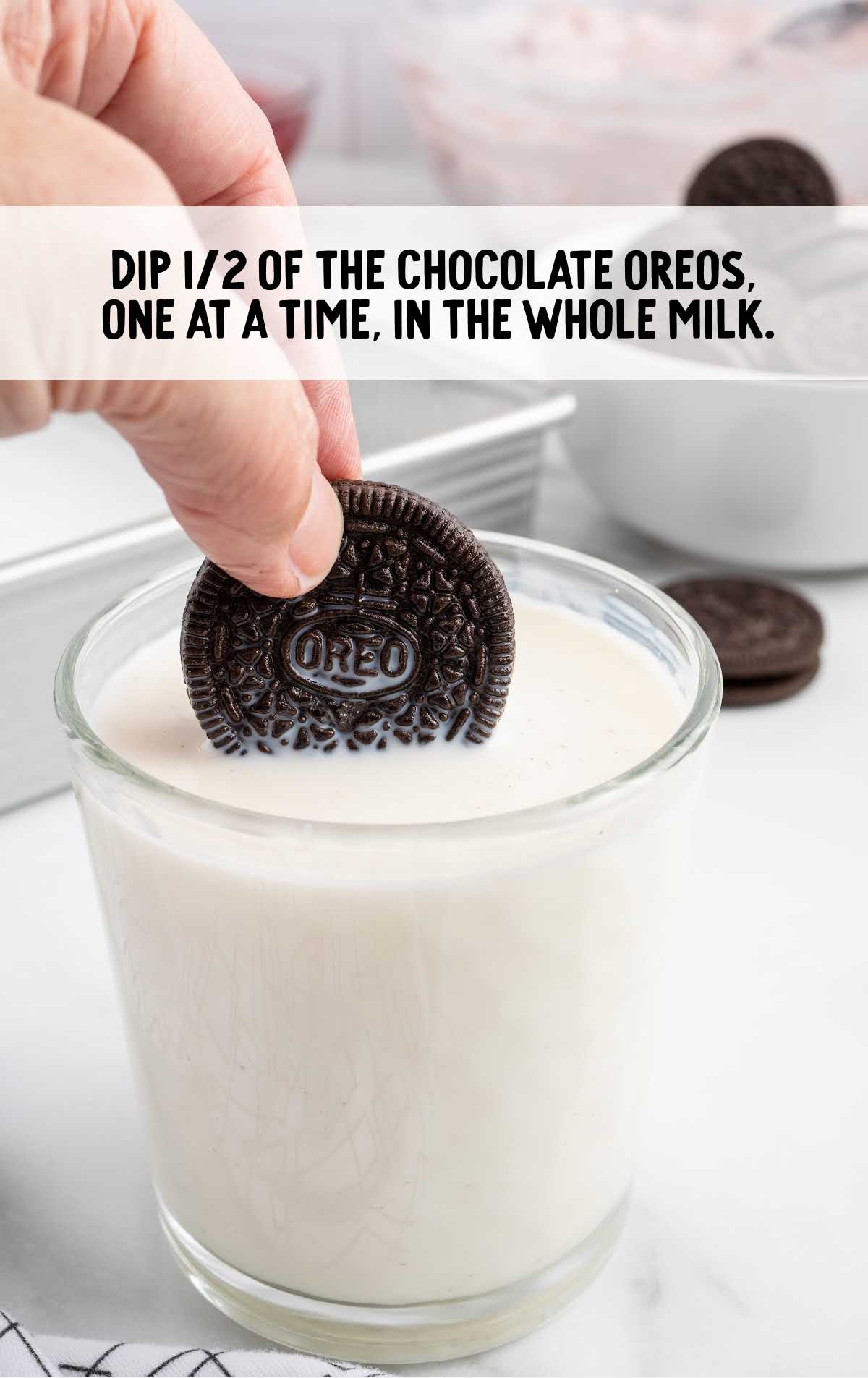 chocolate Oreos dipped into a glass of milk