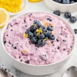 a bowl of Blueberry Fluff topped with blueberries and lemon zest