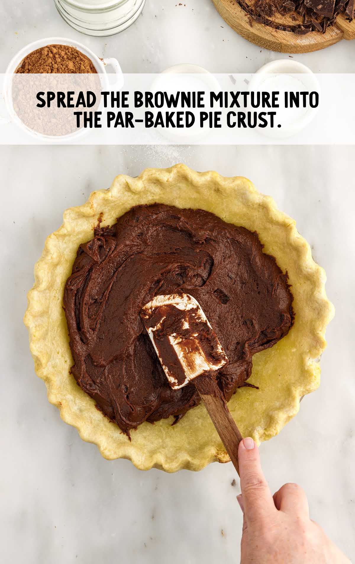 brownie mixture spread into the par-baked pie crust