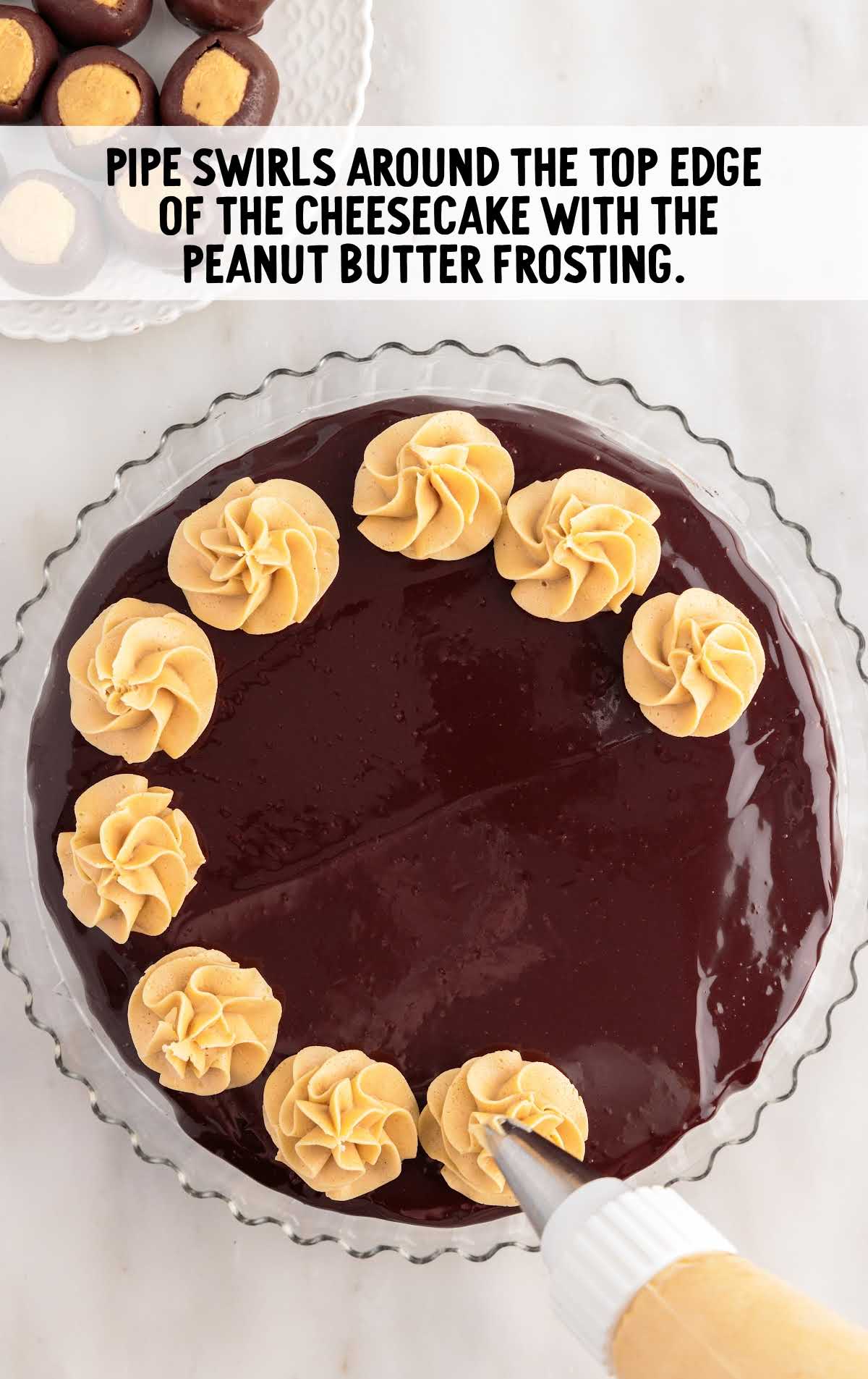 swirls piped around the top edges of the cheesecake with the peanut butter frosting