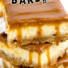 a close up shot of Caramel Cheesecake Bars stacked on top of each other on a plate