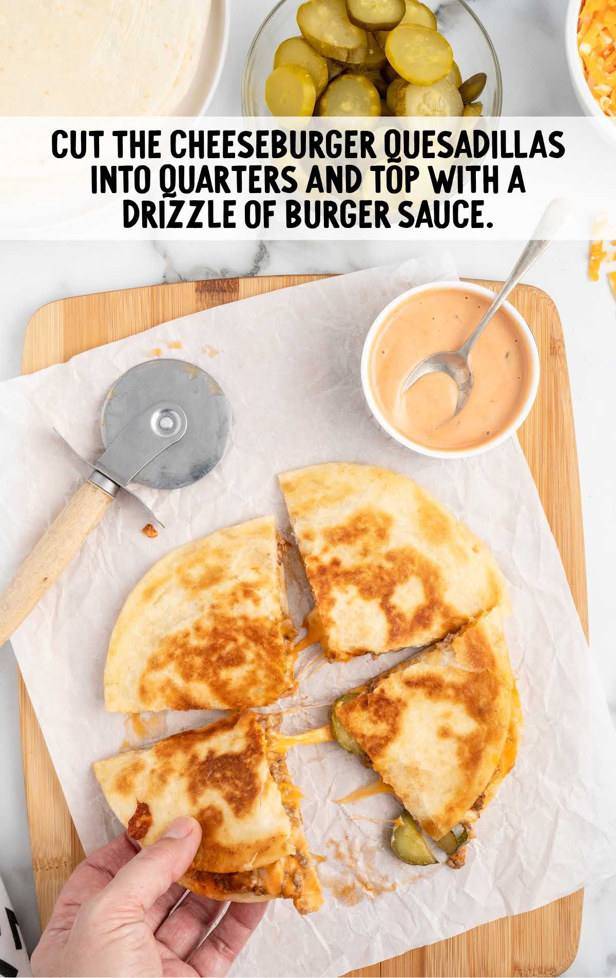 cheeseburger quesadillas cut into quarters and drizzled with burger sauce