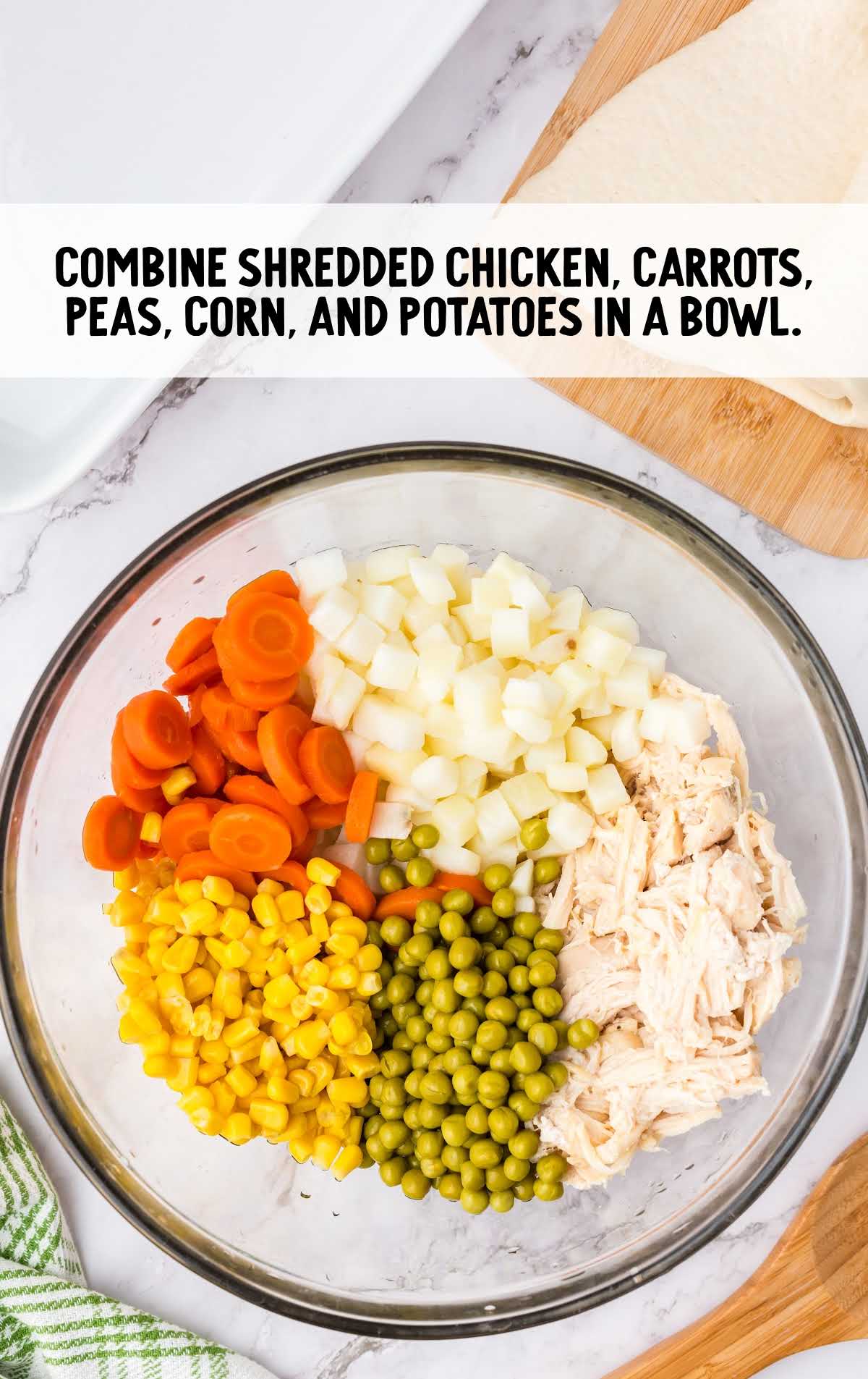shredded chicken, carrots, peas, corn, and potatoes combined together