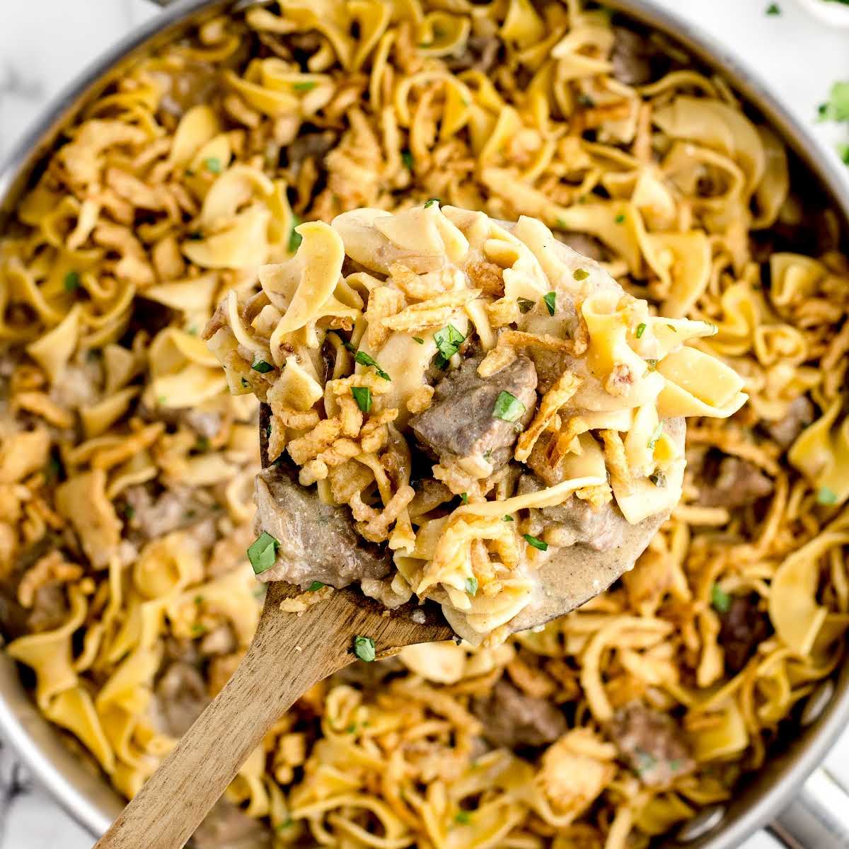 overhead shot of a wooden spoonful of French Onion Beef