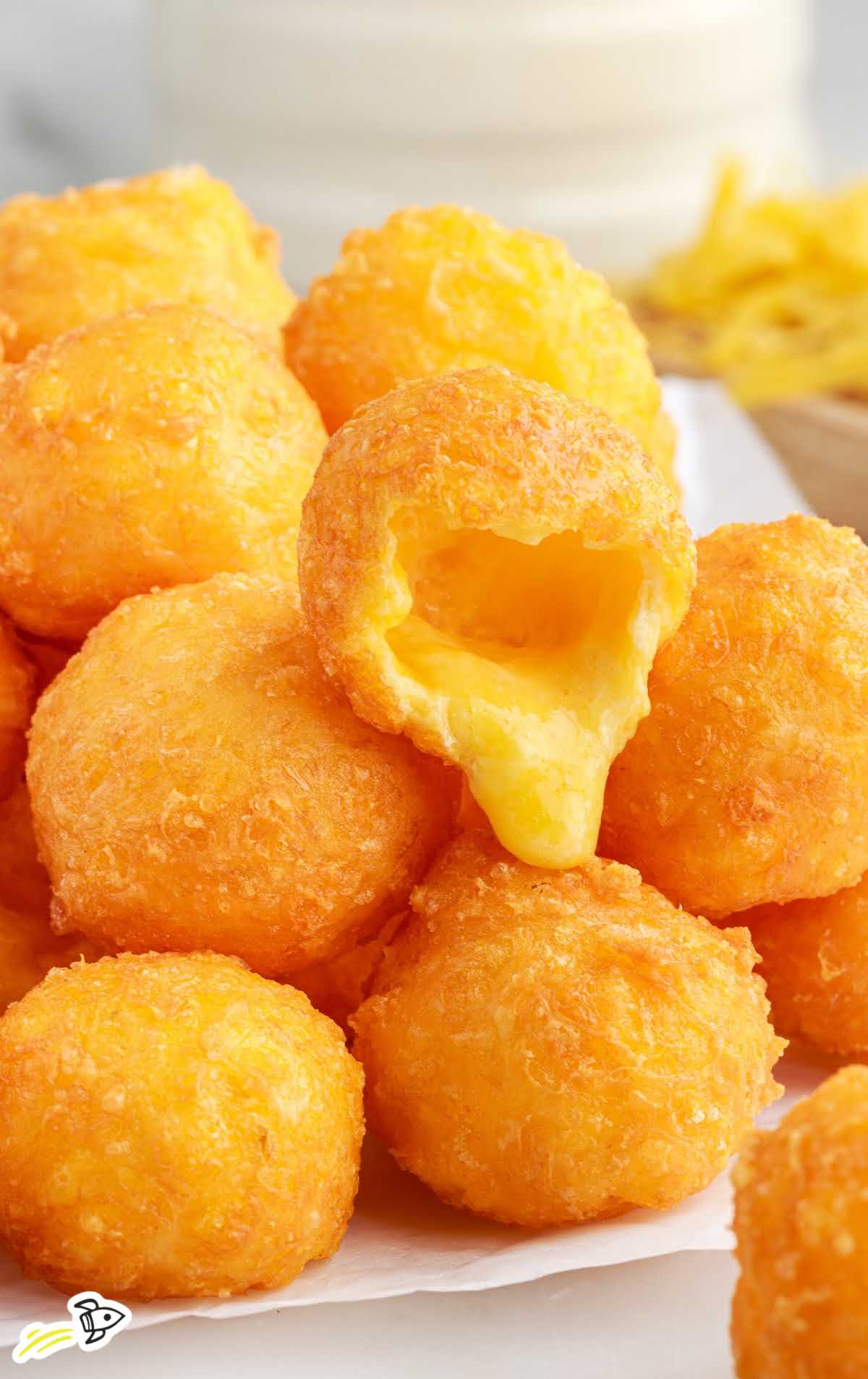 close up shot of Fried Cheese Balls piled on a plate