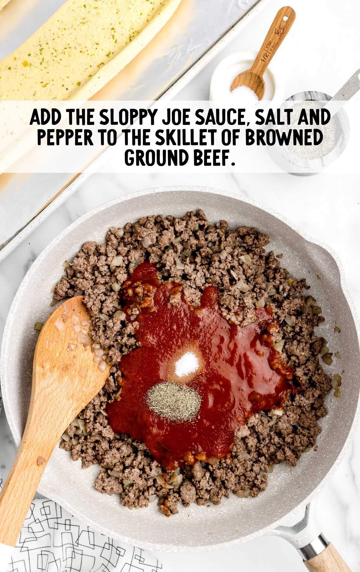 sloppy joe sauce, salt, and pepper added to a skillet