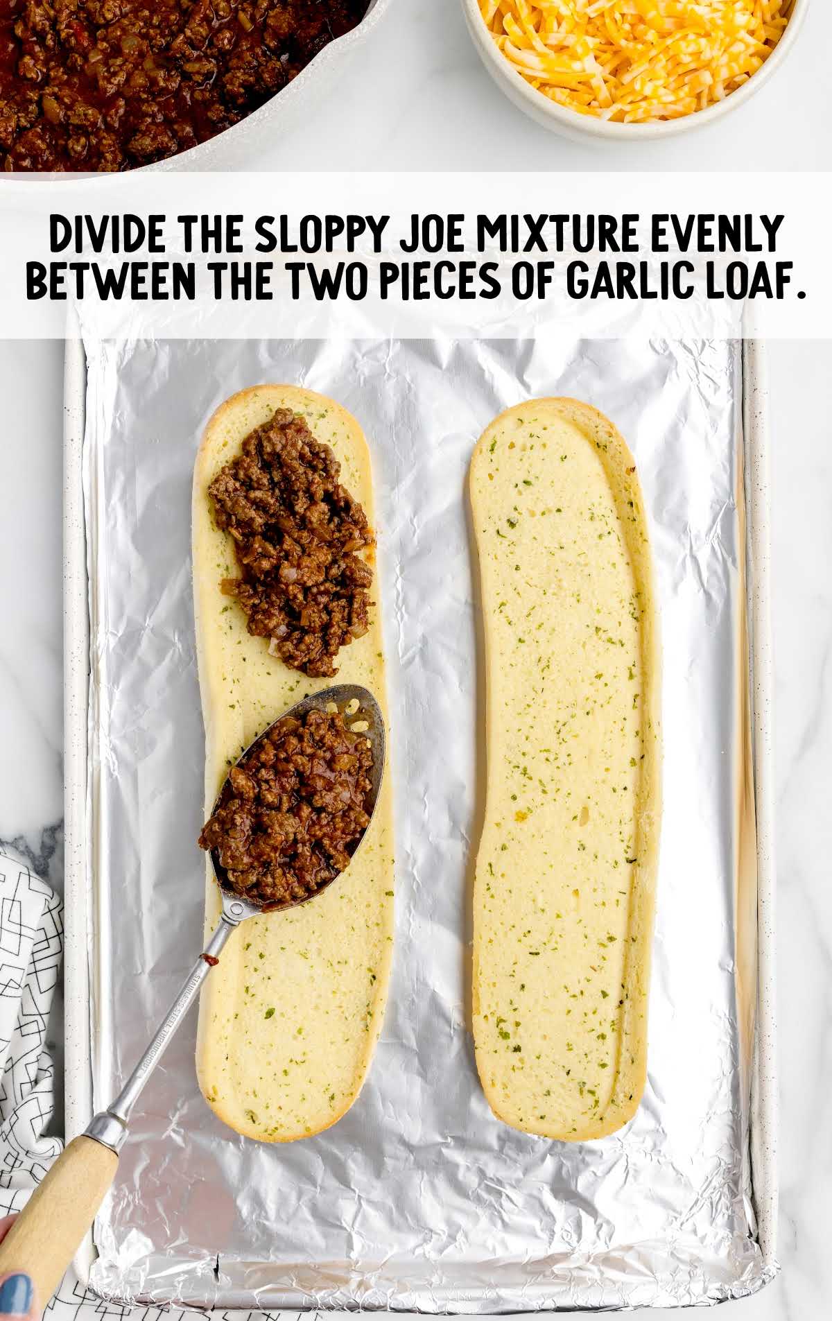 sloppy joe mixture spread between the two pieces of garlic loaf