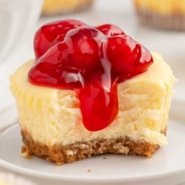 a Mini Cheesecake topped with pie filling on a plate