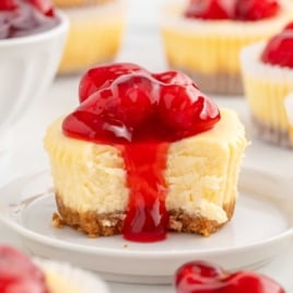 a Mini Cheesecake topped with pie filling on a plate