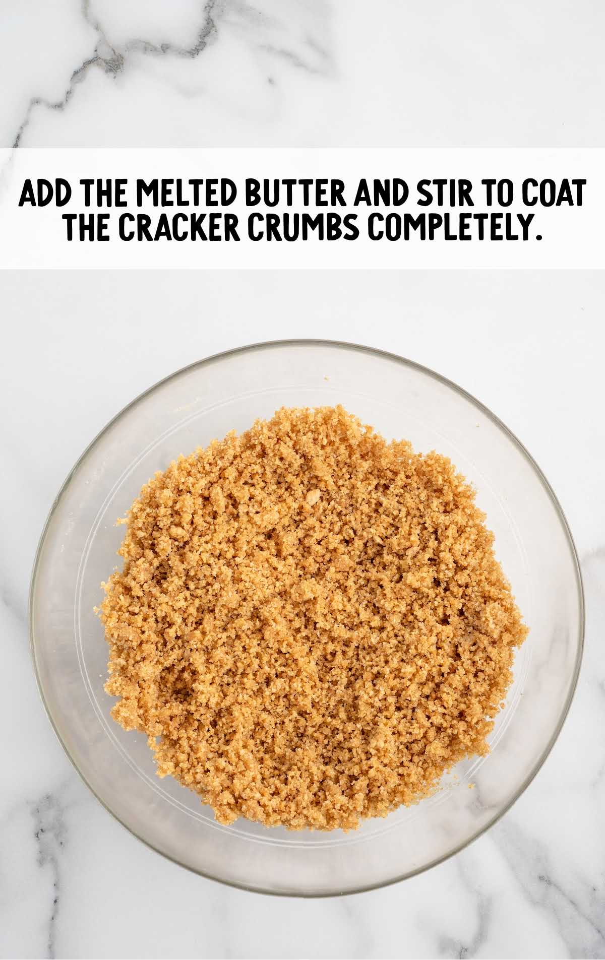 melted butter added to the cracker crumbs in a bowl