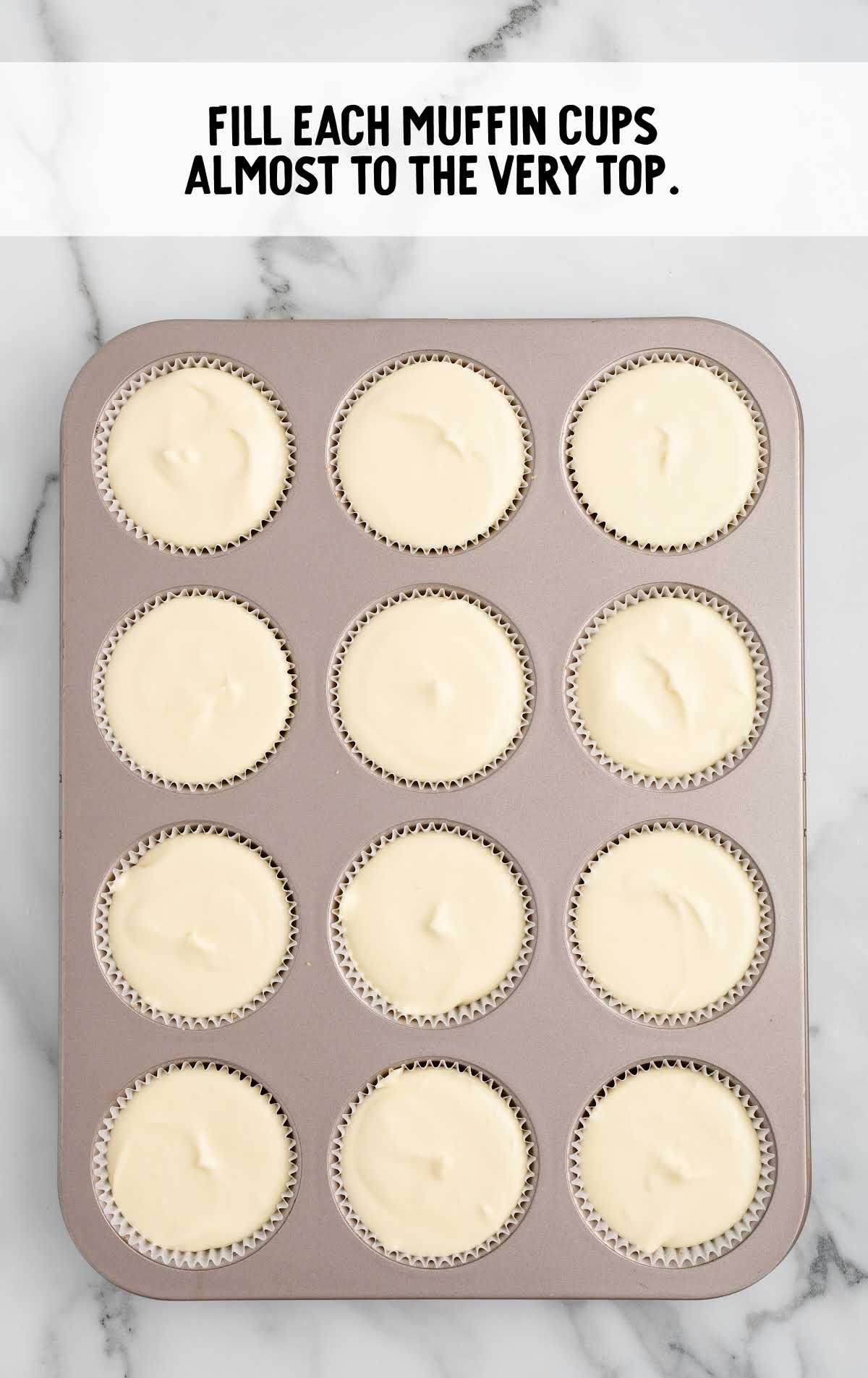 muffin pan filled with the cheesecake mixture