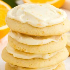 a close up shot of Orange Cookies stacked on top of each other