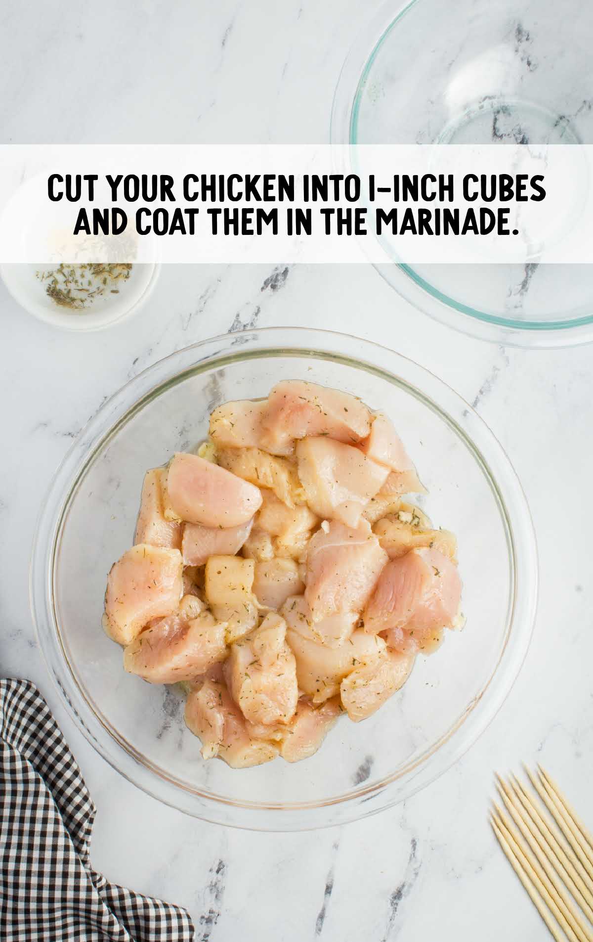 cut up chicken cubes in a bowl of marinade