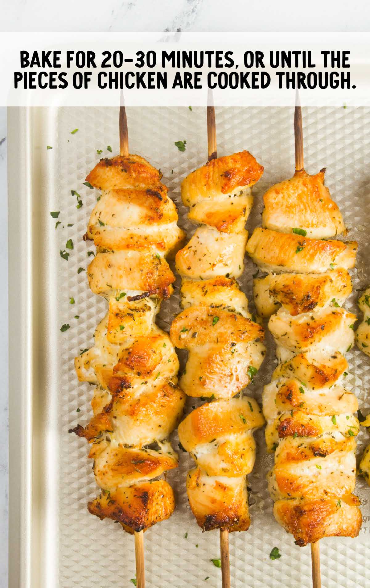 chicken kabobs baked on a baking sheet