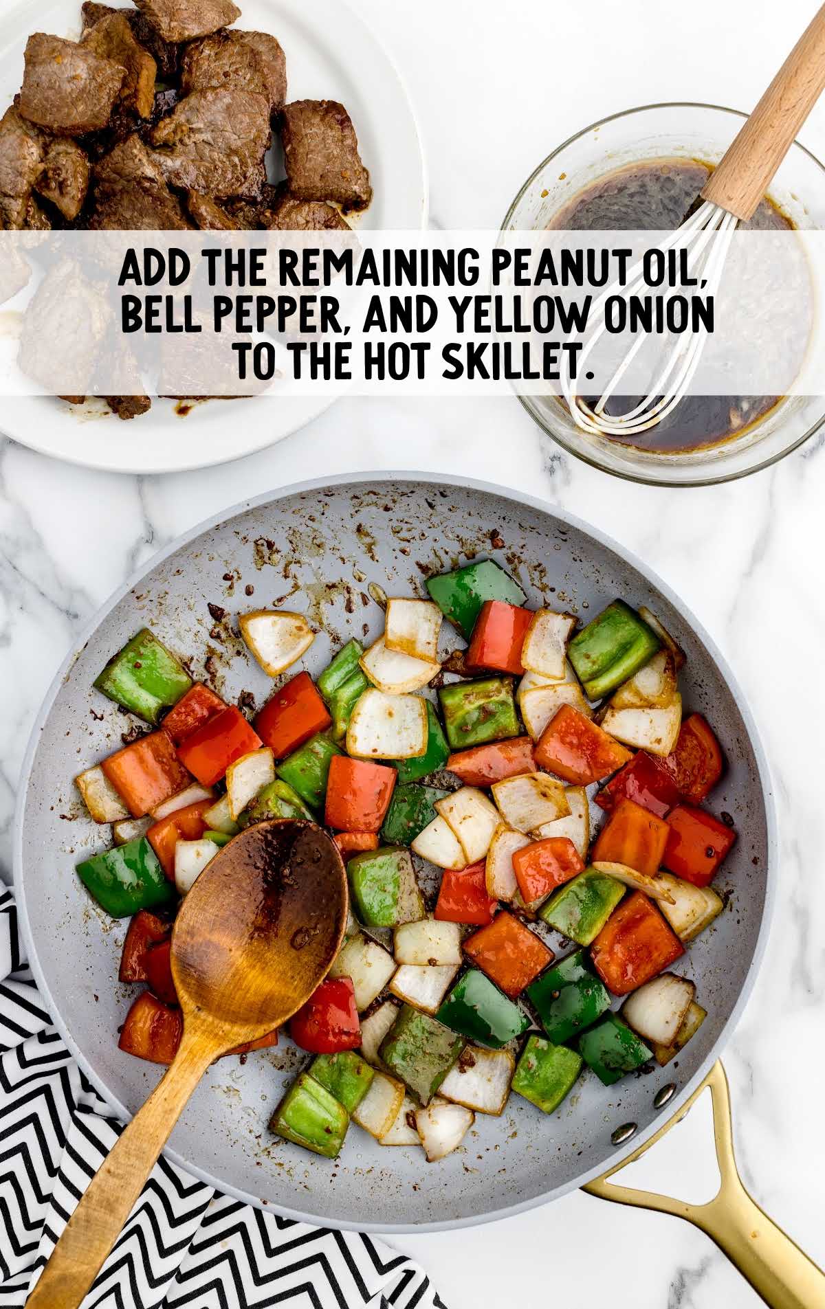 peanut oil, bell pepper, yellow onion, added to skillet