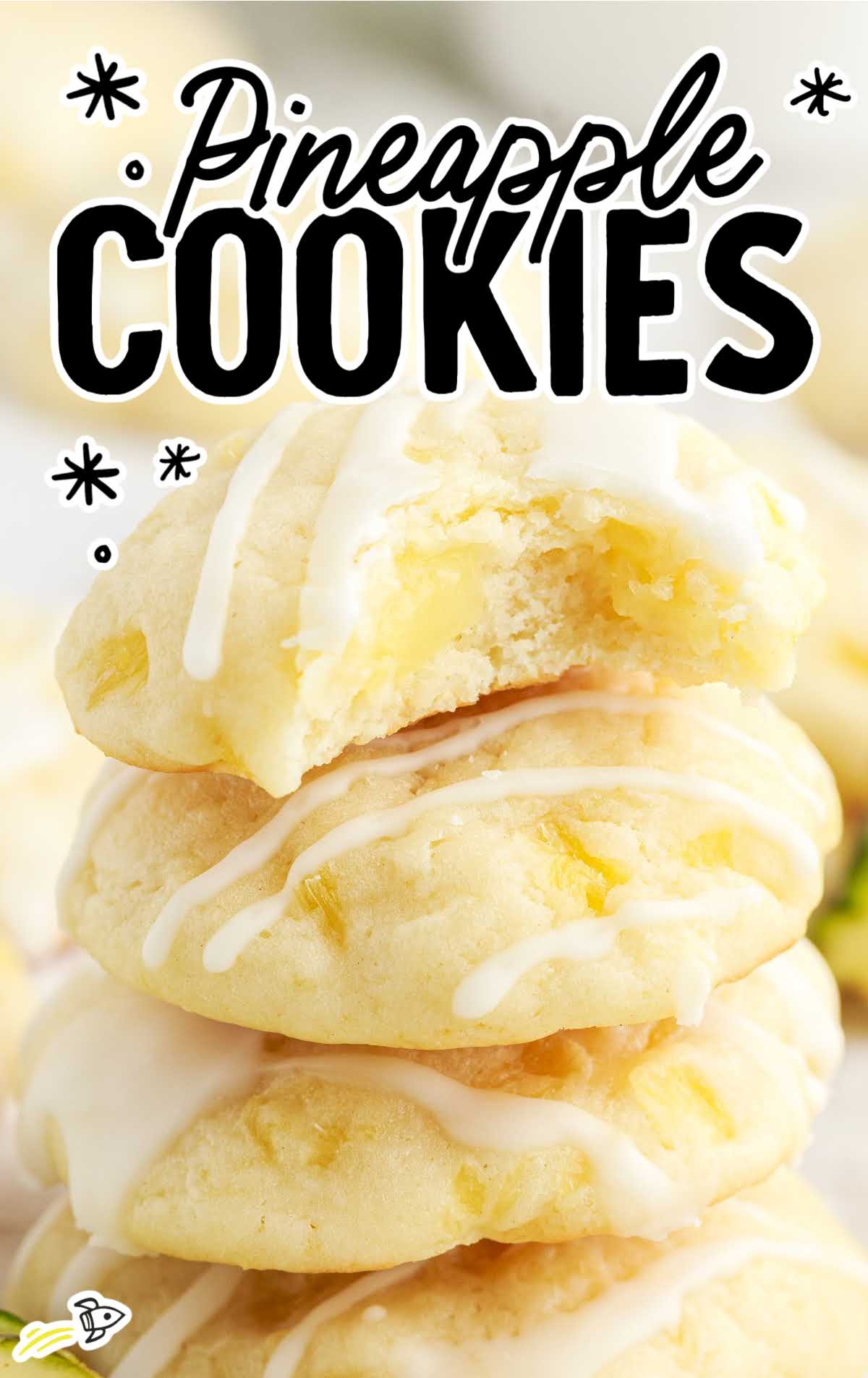 a close up shot of Pineapple Cookies stacked on top of each other with one having a bite taken out of it