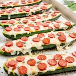 a close-up shot of Pizza Zucchini Boats in a baking dish