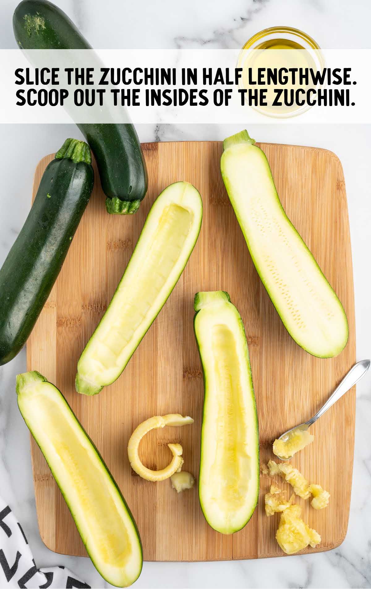 zucchini sliced in half on a wooden board