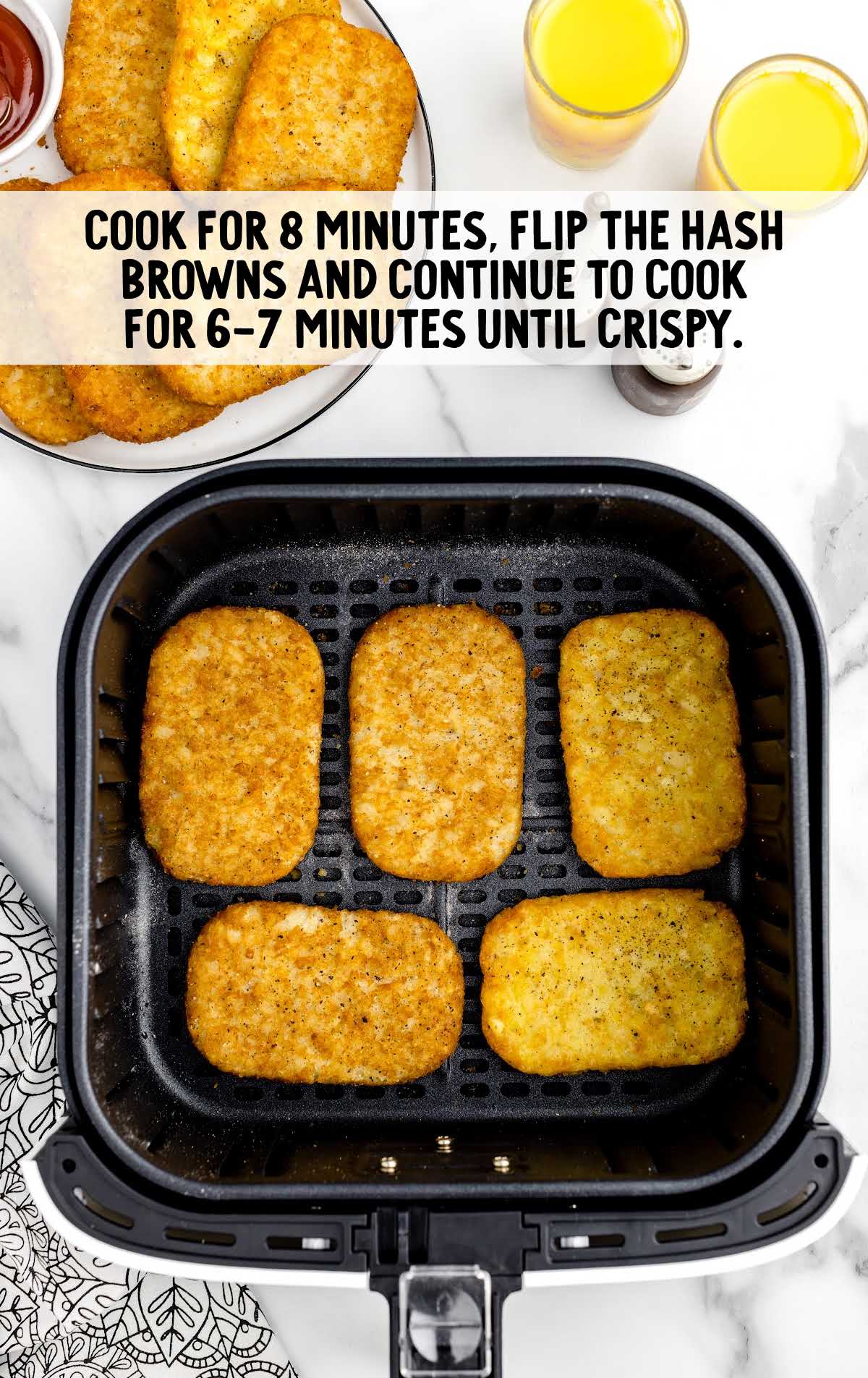 hash browns being cooked in an air fryer