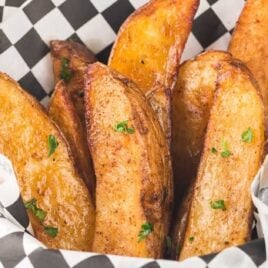 Close-up shot of Air Fryer Potato Wedges in a basket.
