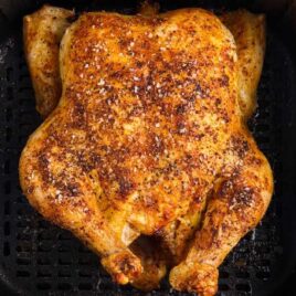 overhead shot of a whole chicken in a air fryer