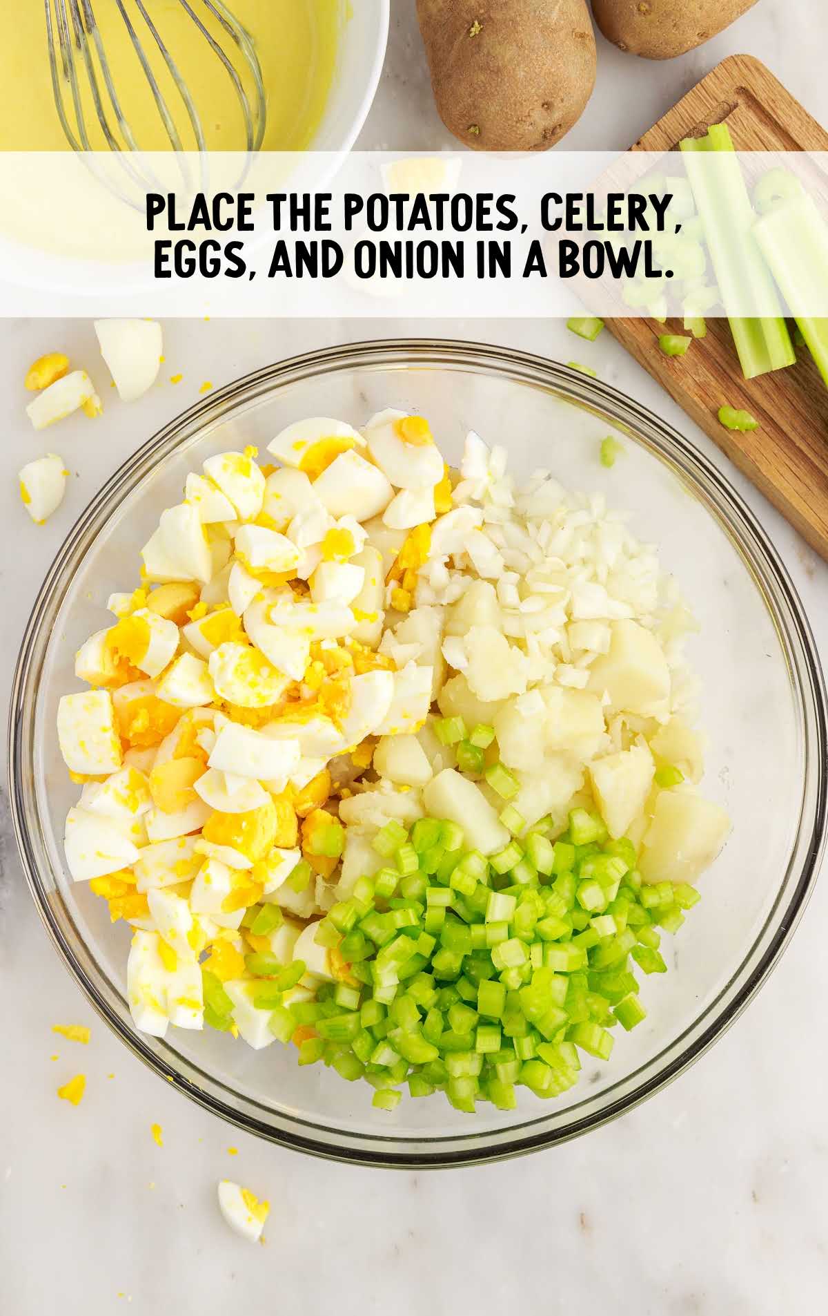 potatoes, celery, eggs, and onion placed in a bowl