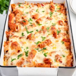Rigatoni garnished with parsley in a baking dish