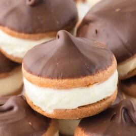 A close-up shot of Eclair Cookies piled on top of each other.