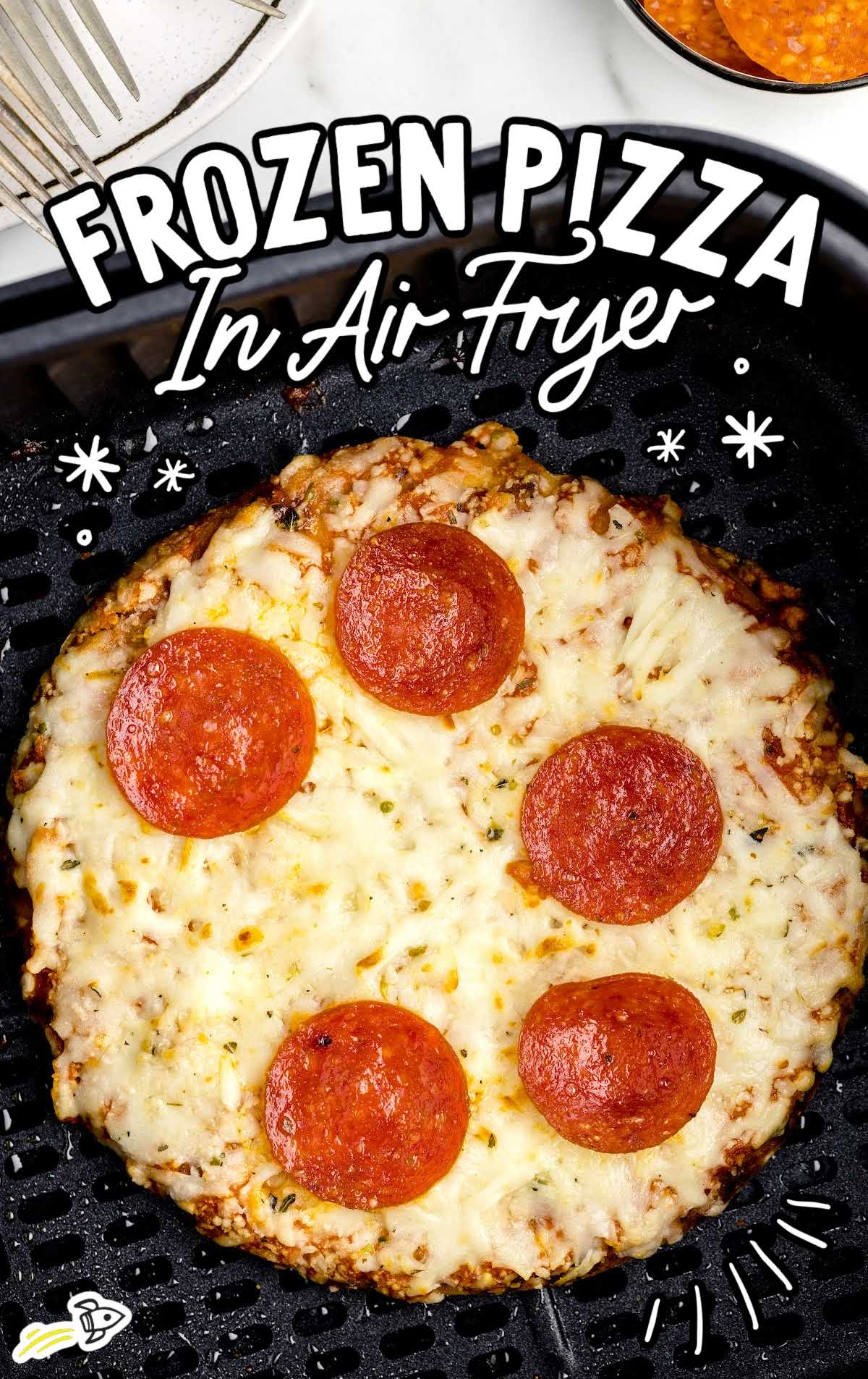 overhead shot of frozen pizza in an air fryer