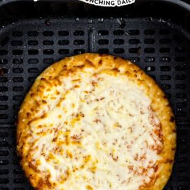 overhead shot of frozen pizza in an air fryer