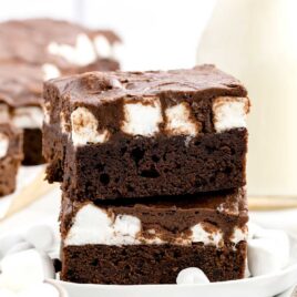 close up shot of Marshmallow Brownies stacked on top of each other on a plate