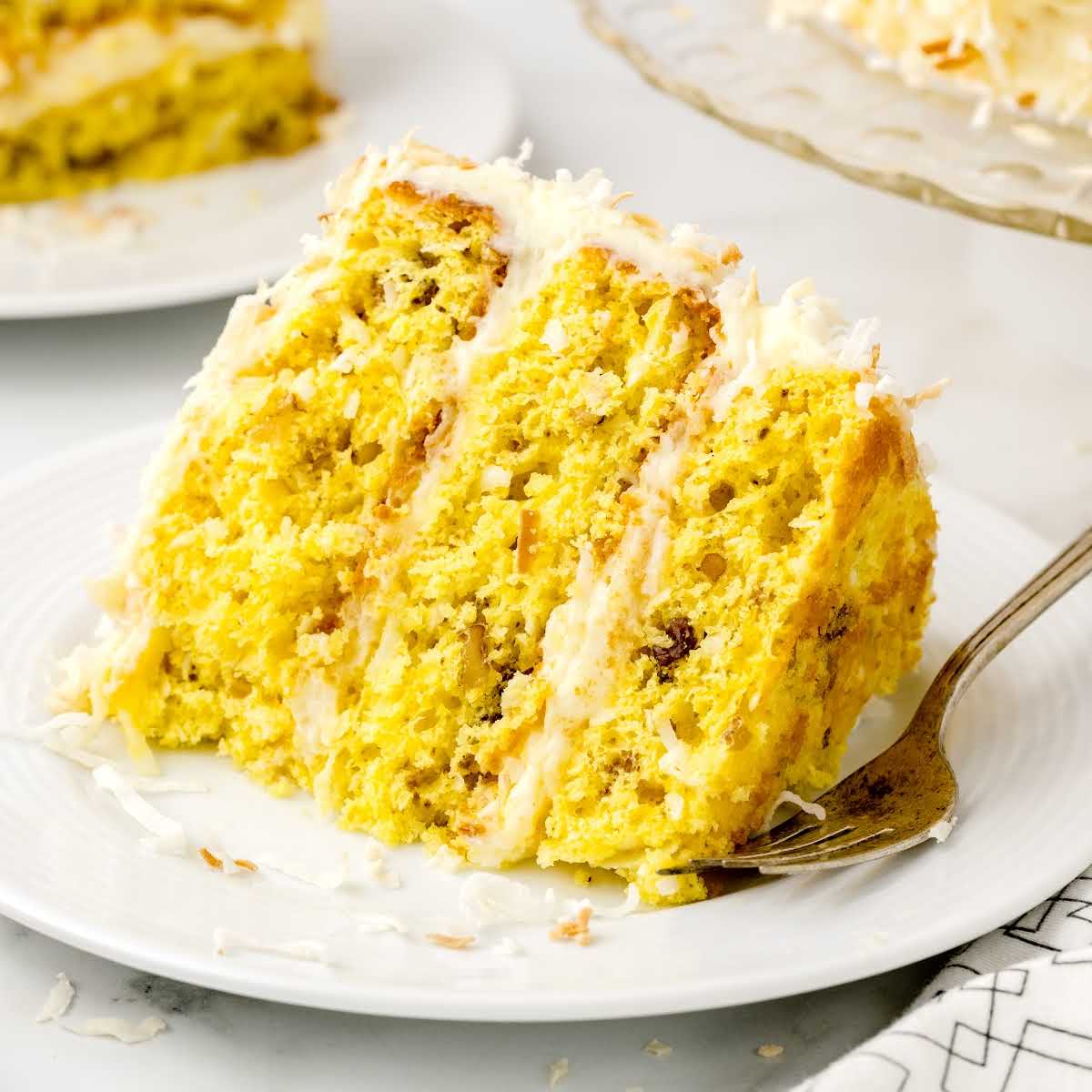 close-up shot of a slice of Million Dollar Cake on a plate with a fork