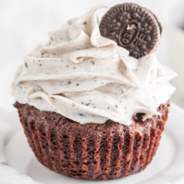 An Oreo cupcake on a white platter.