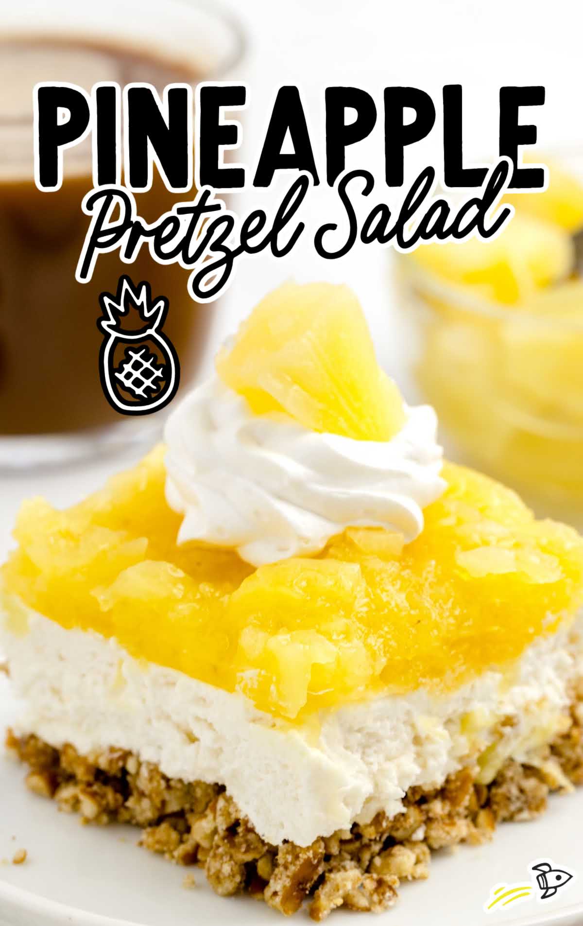 a close up shot of a slice of Pineapple Pretzel Salad on a plate