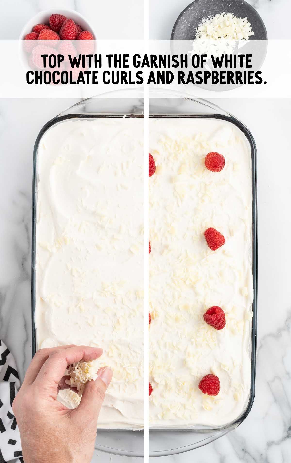 cake topped with white chocolate curls and raspberries