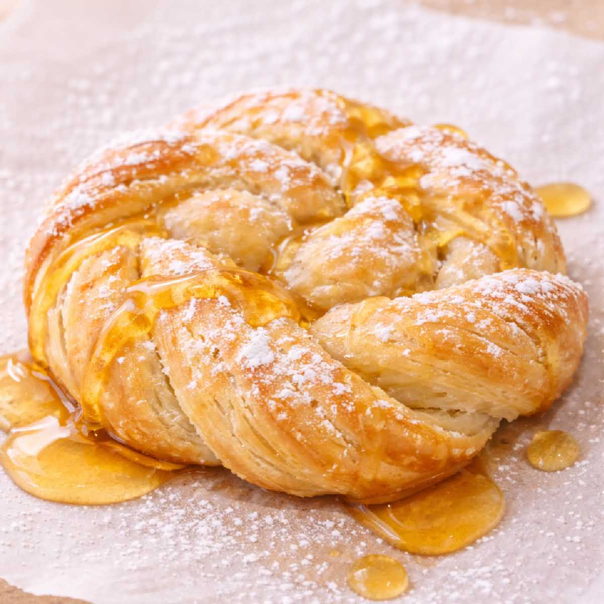 Easy honey danish recipe made with puff pastry, baked until flaky and finished with powdered sugar