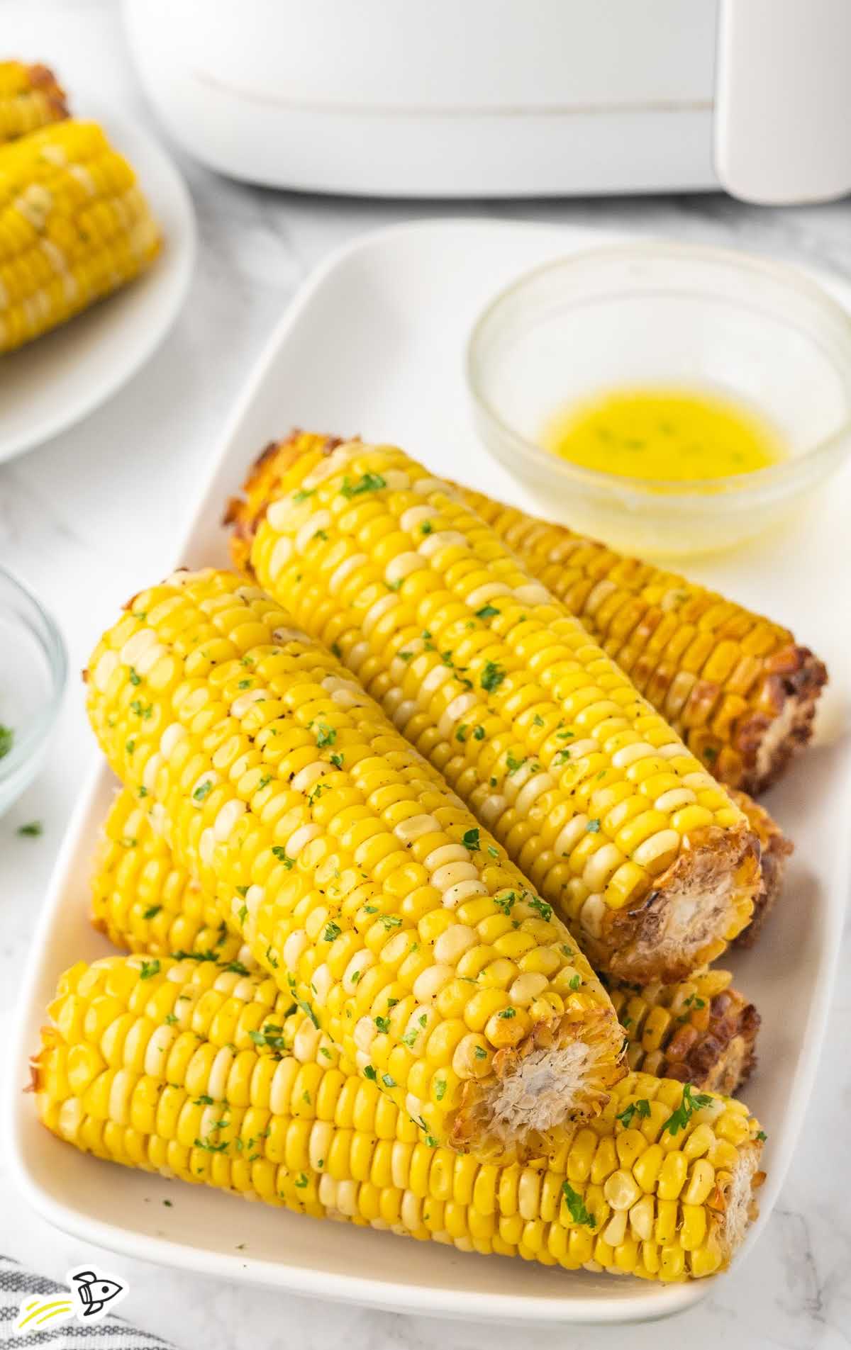 close up shot of Air Fryer Corn On The Cob on a plate
