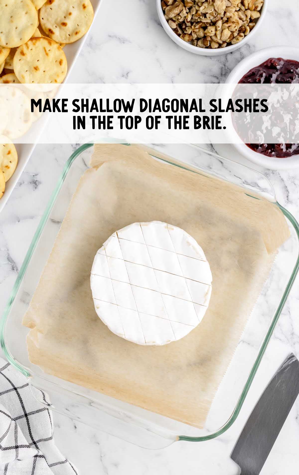 diagonal dashes cut in the top of the baked brie