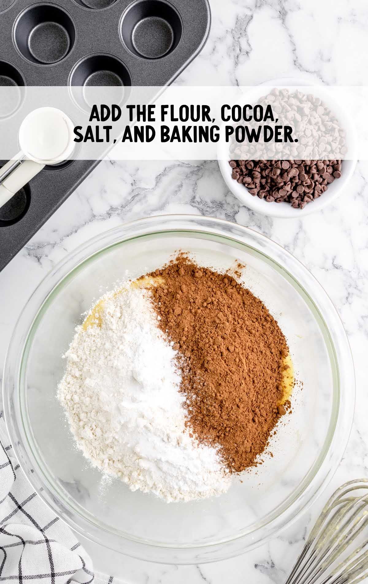 flour, cocoa powder, salt, and baking powder added to a bowl