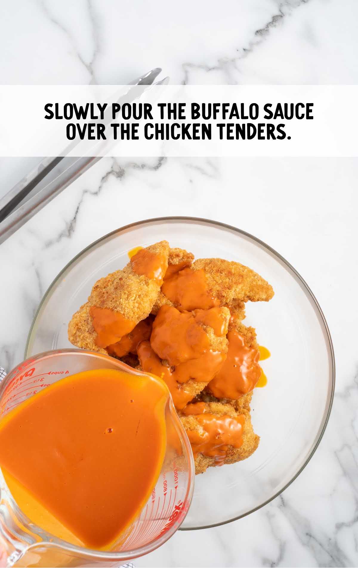 Buffalo sauce poured over the chicken tender