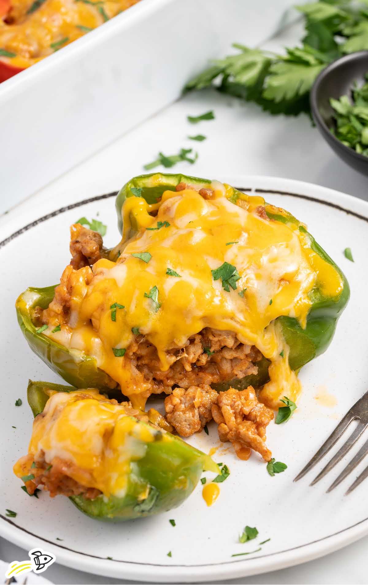 close up shot of a Chicken Stuffed Pepper on plate with a piece taken out of it