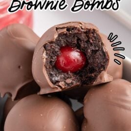 close up shot of a bowl of Chocolate Covered Cherry Brownie Bombs with a bite taken out of one of the brownie bombs
