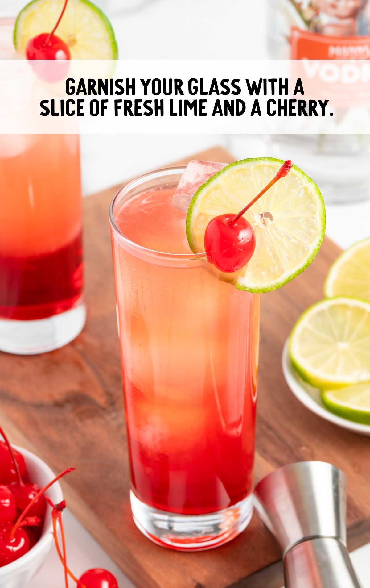 slice of lime and cherry garnished on the glass
