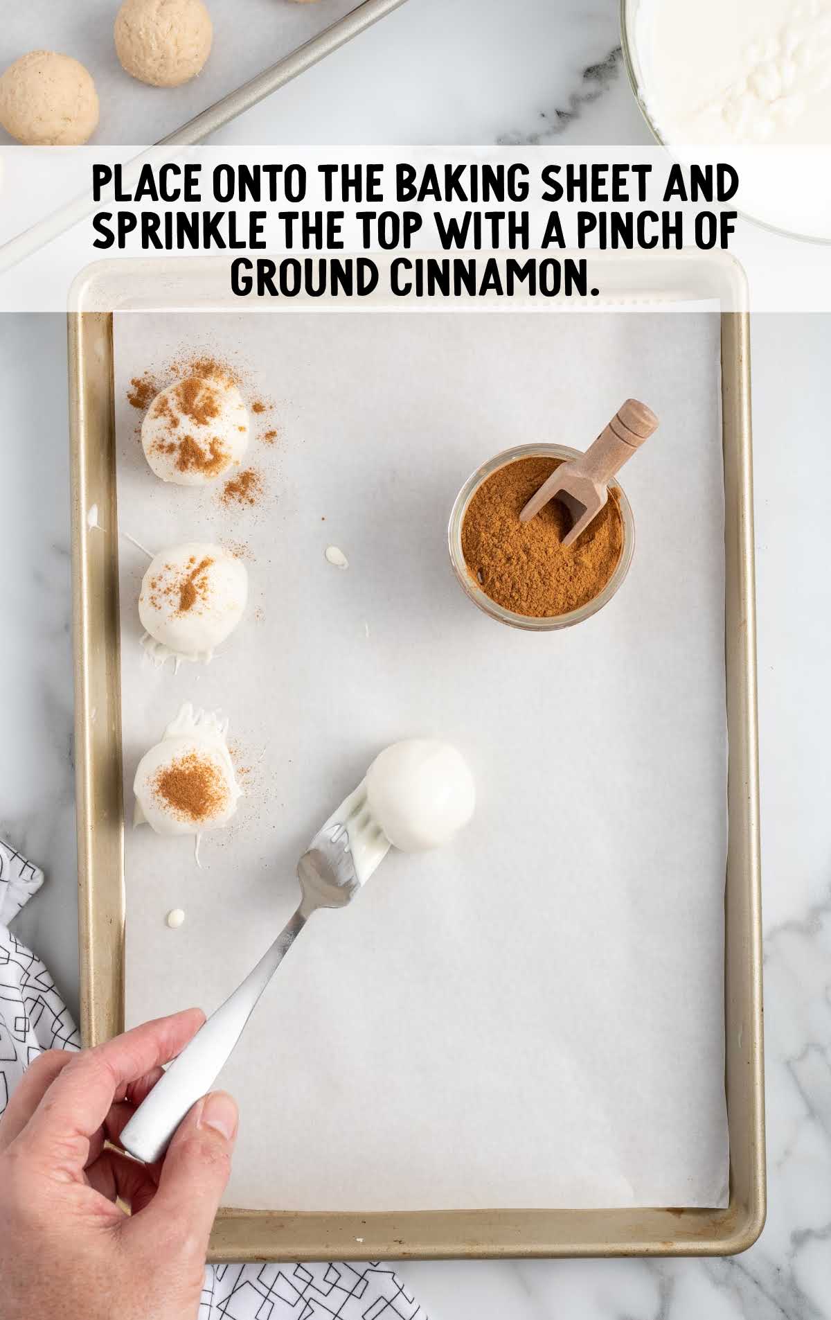 place balls onto the baking sheet and sprinkle cinnamon