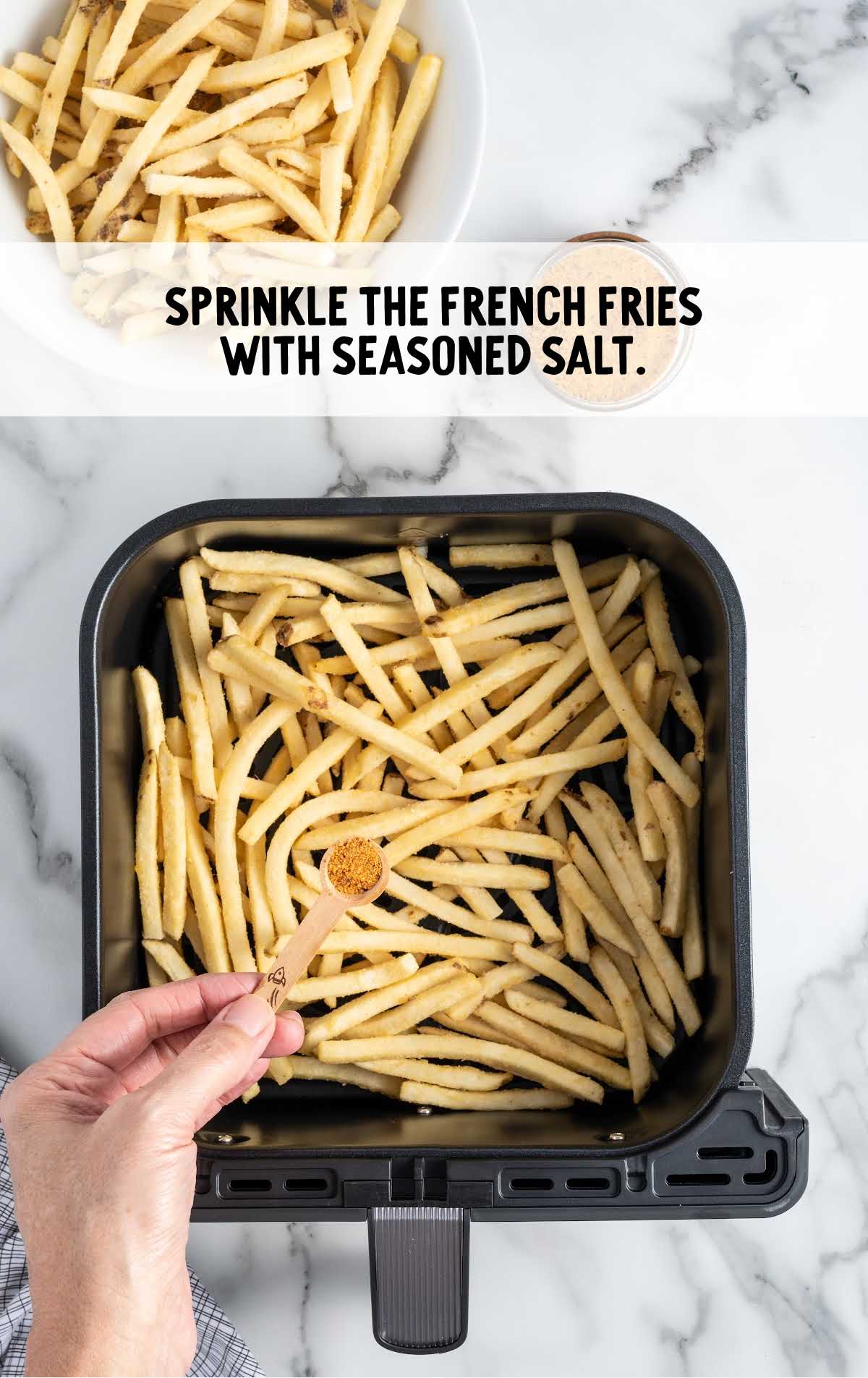 seasoned salt sprinkled on top of the fries